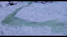 Remarkable video shows Canadian stream 'disappearing' as it freezes over in a matter of seconds