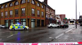 Police cordon off area after car crash damages building on a busy high street in Enfield