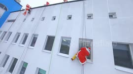 Santas abseil down walls of children's hospital to cheer up cancer patients