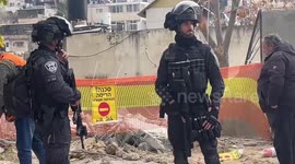 An Israeli bulldozer demolishes a house