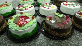 Palestinian chefs put final touches on cakes which portrays the new year number