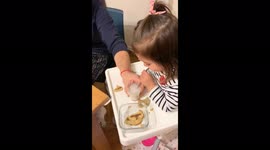 the baby around 2 years old Froating milk up and enjoy with her father with her straw