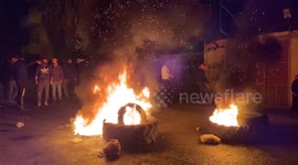 Palestinian demonstrators set wheels on fire during clash with Israeli forces in Nablus city, West Bank