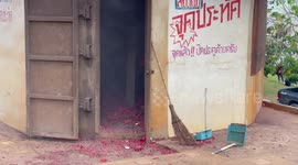 Locals set off fire crackers to celebrate New Year at Buddhist temple in southern Thailand