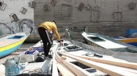 Palestinian fishermen repair boats destroyed by Israeli forces