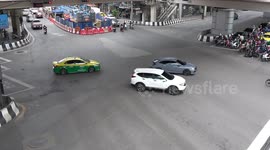 Vehicles negotiate busy intersections in Bangkok, Thailand
