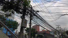 Shocking mess of black electricity and communication cables in Bangkok, Thailand