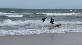 Kite surfer enjoys windy weather on beach in southern Thailand
