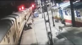 Moment a woman is saved from coming under a train by alert railway police officials in central India
