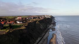 Seaside homes left dangling on cliff edge after huge landslide in Norfolk, UK