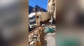 Transport truck left teetering off CLIFF EDGE in botched reverse along Chinese mountain road