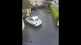'Security camera catches man falling over while walking down slippery driveway '