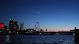 A Stunning Crescent Moon Over The London Eye In London