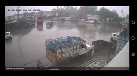 Watch - Women on scooty miraculous escape , after quick truck driver applied brakes after hitting scooty