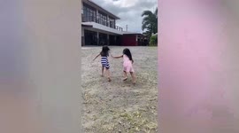Little girls use gate to make fireworks sounds during New Year in the Philippines