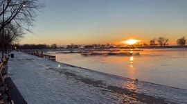 Winter sunrise in Chicago at Montrose Harbor. Steam fog rising off the frigid waters.