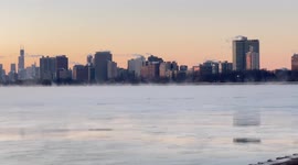 Winter sunrise in Chicago at Montrose Harbor. Steam fog rising off the frigid waters.