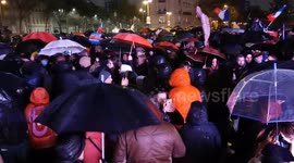 Crowd improvises dance under the rain at protest against COVID passports in Paris