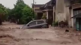 Vehicle swept through city streets as flood strikes Indonesia