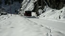 Officials carry out snow clearance operations in northern India