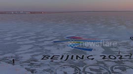 Art teacher paints giant 6,000 sqm Beijing Olympics logo on frozen river in northeastern China