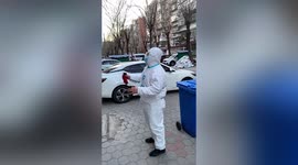 Volunteer plays Chinese instrument while shouting to urge residents to do COVID-19 tests