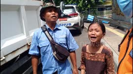 Hysterically crying a child cries when his parents' motorbike is picked up by officers at the Tanah Abang market