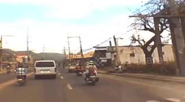 Lucky motorcycle passenger just inches from having head crushed after falling under truck