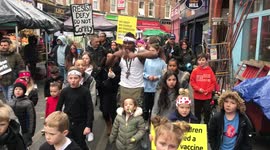 Children sing anti vacine song in Brixton as protesters say the vacine as health risks