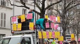 A man shows his middle finger from his balcony to contest against the anti-abortion demo. 16jan2022. Paris, Tour Montparnasse.