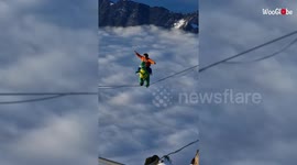 Thrill seeker takes on 1,500-metre-high slackline dressed as a dinosaur