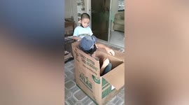 Seafarer dad hides inside box to surprise son he hasn't seen in months