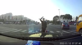 Bizarre moment scooter rider blocks traffic to salute car in China