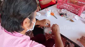 Thai housewives recycle used lottery tickets by turning them into pretty handmade ornaments