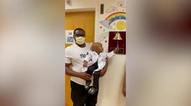 Heartwarming moment two-year-old finally rings the bell to signify the end of chemo in the comfort of his fathers arms