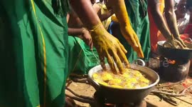 Devotees plunge their hands into boiling oil to prove their faith during Indian ritual