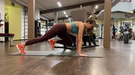 Fitness trainer from Moscow, Russia shows a dynamic plank with legs exercise