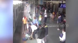 Indian man nearly dragged under moving train while trying to board