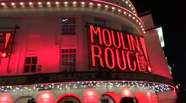Lively atmosphere outside the Piccadilly Theatre with Moulin Rouge! performance about to begin