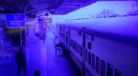 Indian officers haul passenger to safety after he slips into gap while boarding moving train