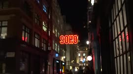 Neon SOHO sign illuminates Beak Street in London Soho