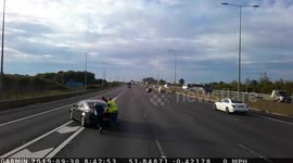 Truck drivers rescue car stranded in the middle of the road. M1 motorway, Luton, Bedfordshire, UK