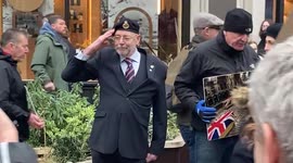 Ex-serviceman on London’s Regent Street salutes anti-vaccination protestors