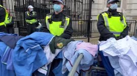 NHS workers against mandatory covid19 vaccines throw their scrubs over Downing Street