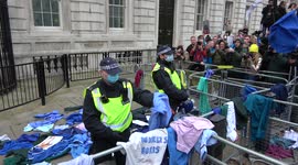 NHS nurses HURL their uniforms at Downing Street gates to protest against vaccine mandates