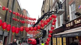 Workers install new red lanterns in London's Chinatown, ahead of Chinese New Year