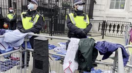 'Throw our uniforms over! Shame on you!' Angry NHS workers throw uniforms at MET police while crowds clapped and cheered