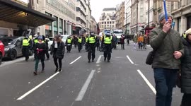 Police following behind the London world wide rally for freedom