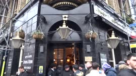 Football fans singing loudly during live stream of a game at Courtfield pub - Earls Court