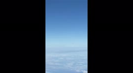 Strange UFO seen flying in clouds from Ryanair flight to Budapest